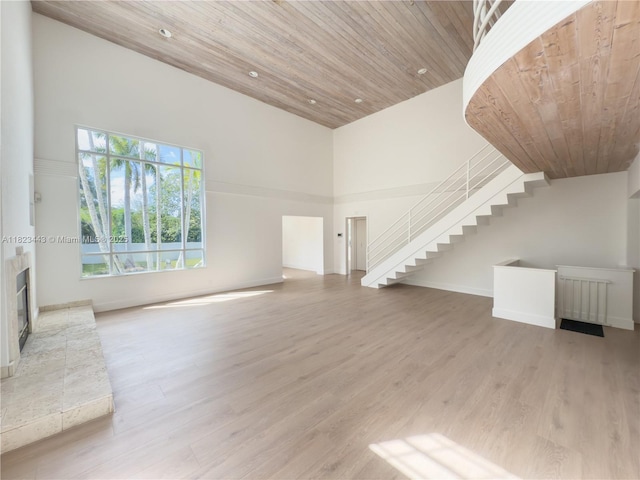 8390 SW 94th St, Miami, FL 33156 - unfurnished living room featuring a towering ceiling, wood finished floors, stairway, wood ceiling, and recessed lighting