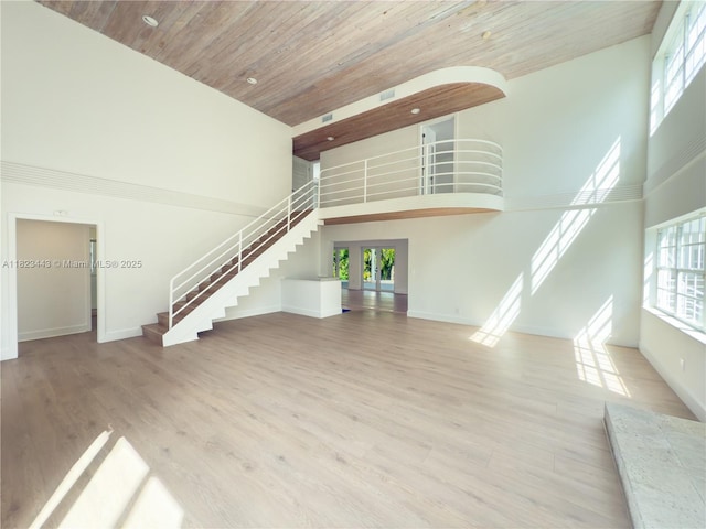 8390 SW 94th St, Miami, FL 33156 - unfurnished living room with a high ceiling, stairway, wooden ceiling, french doors, and wood finished floors