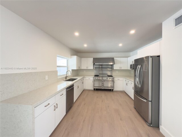 8390 SW 94th St, Miami, FL 33156 - kitchen with stainless steel appliances, light wood-type flooring, range hood, white cabinets, and recessed lighting