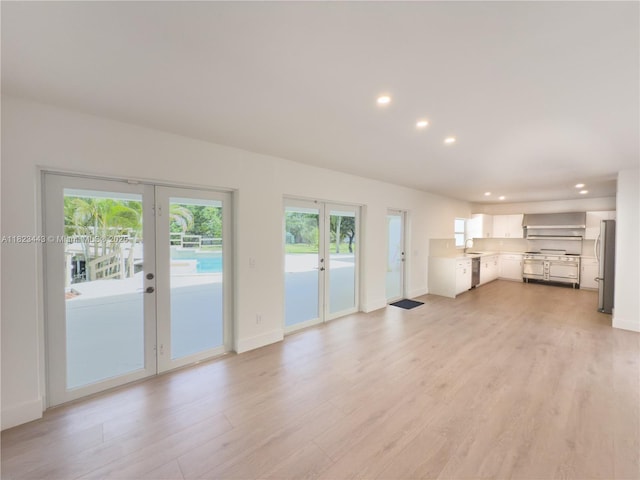 8390 SW 94th St, Miami, FL 33156 - unfurnished living room featuring french doors, recessed lighting, and light wood finished floors