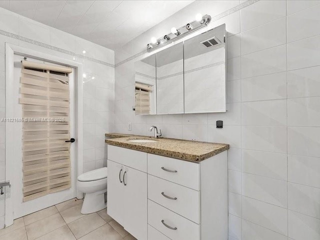 1870 NE 208th Ter, Miami, FL 33179 - bathroom featuring tile walls, vanity, and tile patterned flooring