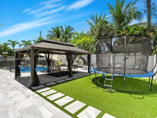 1870 NE 208th Ter, Miami, FL 33179 - view of community featuring a trampoline, a gazebo, and a fenced backyard