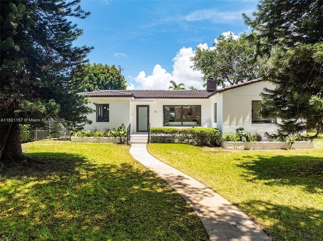 51 NE 110th St, Miami Shores, FL 33161 - mediterranean / spanish house with a tiled roof, a chimney, and stucco siding