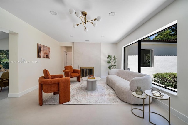 51 NE 110th St, Miami Shores, FL 33161 - living room featuring finished concrete floors, a tiled fireplace, and a chandelier