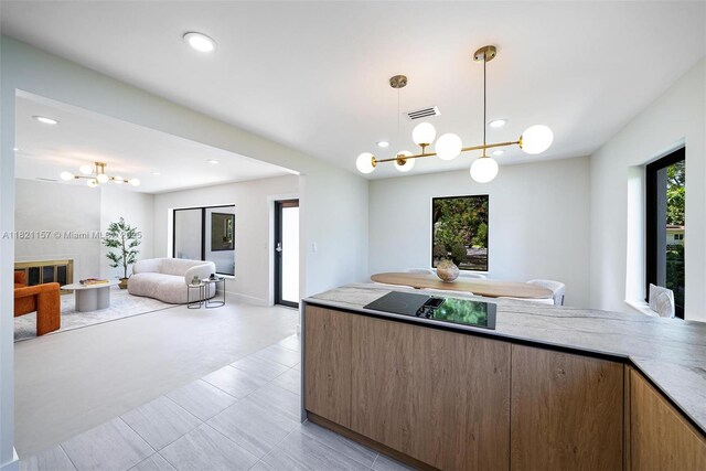 51 NE 110th St, Miami Shores, FL 33161 - kitchen featuring black electric stovetop, a chandelier, hanging light fixtures, open floor plan, and recessed lighting