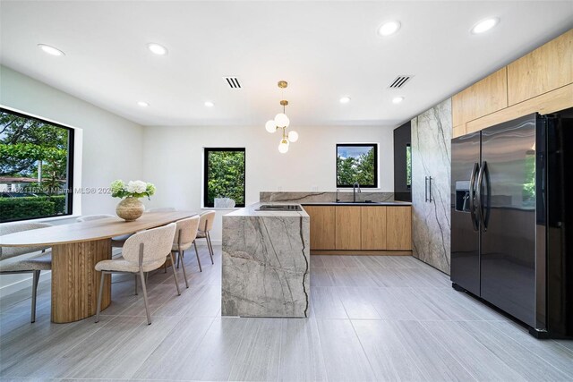 51 NE 110th St, Miami Shores, FL 33161 - kitchen with stainless steel fridge with ice dispenser, modern cabinets, recessed lighting, black cooktop, and hanging light fixtures