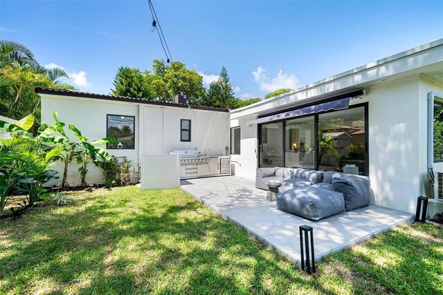 51 NE 110th St, Miami Shores, FL 33161 - back of house featuring exterior kitchen, a yard, stucco siding, and an outdoor living space
