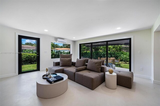 51 NE 110th St, Miami Shores, FL 33161 - living room with plenty of natural light, concrete flooring, recessed lighting, and a wall mounted air conditioner