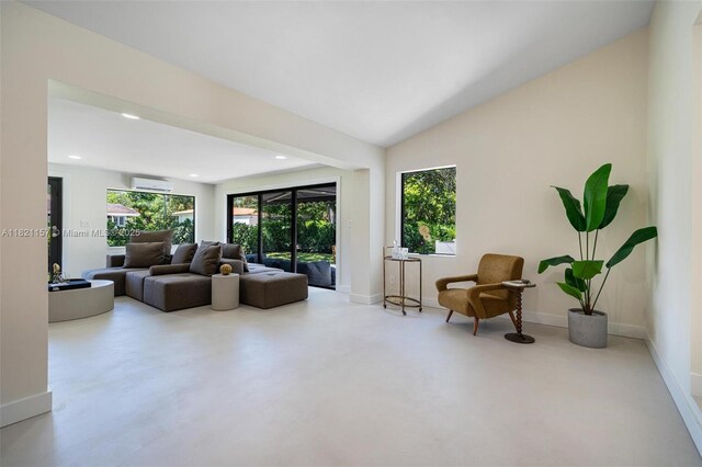 51 NE 110th St, Miami Shores, FL 33161 - sitting room with a wall unit AC, recessed lighting, lofted ceiling, and concrete floors