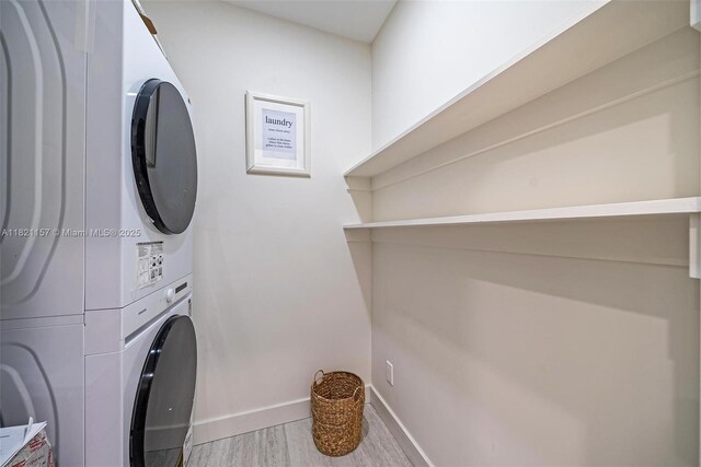 51 NE 110th St, Miami Shores, FL 33161 - laundry area featuring stacked washer / dryer and wood finished floors