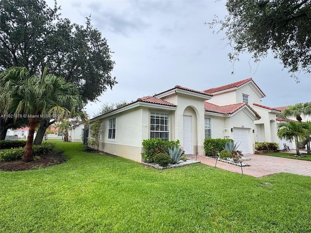 18861 SW 28th Ct, Miramar, FL 33029 - mediterranean / spanish-style home with an attached garage, stucco siding, decorative driveway, a front yard, and a tiled roof