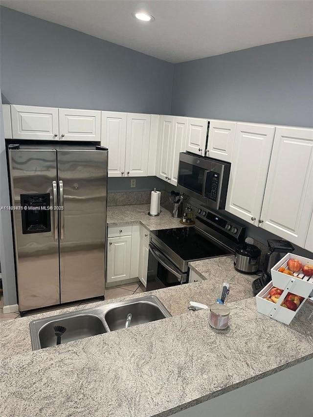 18861 SW 28th Ct, Miramar, FL 33029 - kitchen featuring stainless steel appliances, white cabinets, light stone counters, and recessed lighting