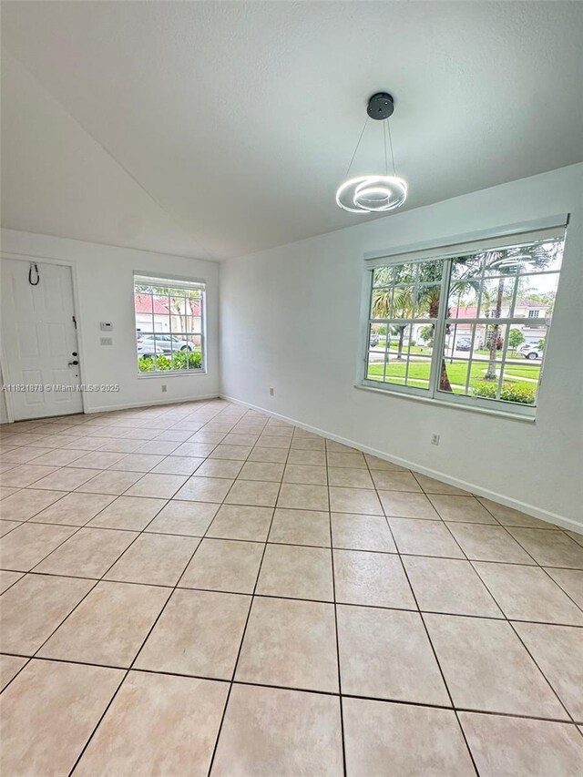 18861 SW 28th Ct, Miramar, FL 33029 - spare room featuring light tile patterned floors, lofted ceiling, and a chandelier