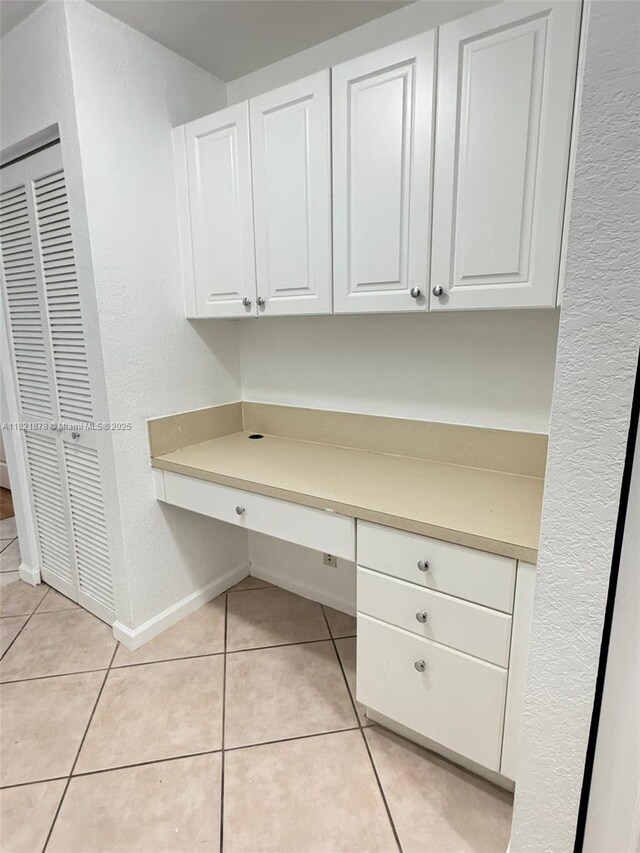 18861 SW 28th Ct, Miramar, FL 33029 - unfurnished office featuring built in desk, light tile patterned floors, and a textured wall