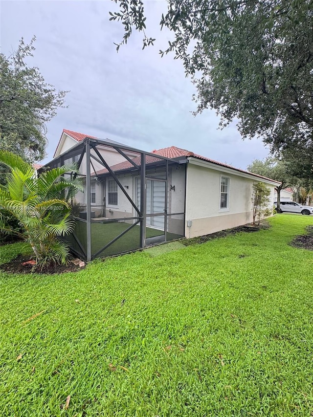 18861 SW 28th Ct, Miramar, FL 33029 - back of property with a lawn, stucco siding, and glass enclosure