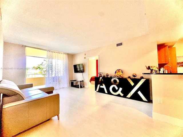 18800 NE 29th Ave Unit 412, Aventura, FL 33180 - living room featuring a textured ceiling