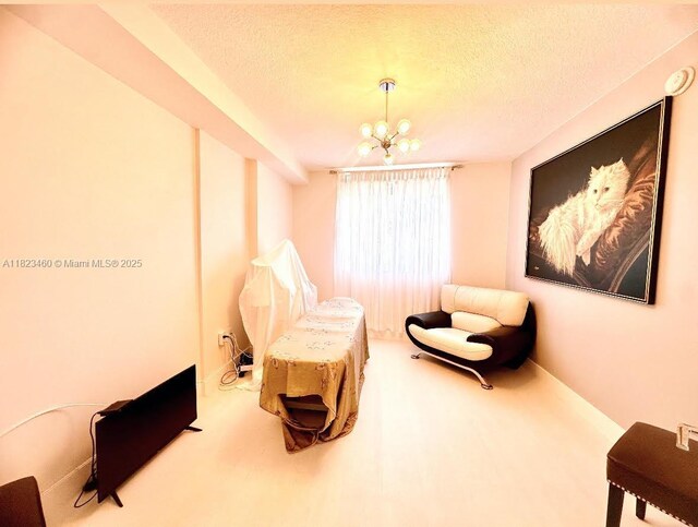 18800 NE 29th Ave Unit 412, Aventura, FL 33180 - sitting room with a textured ceiling, a chandelier, and carpet floors