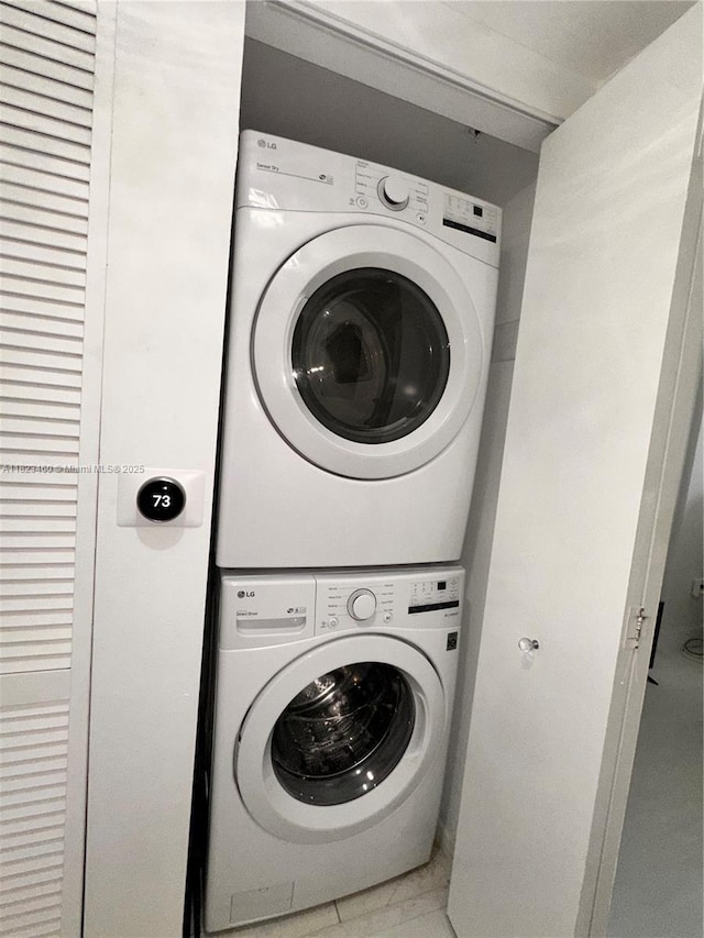 18800 NE 29th Ave Unit 412, Aventura, FL 33180 - laundry area featuring estacked washer and dryer and light tile patterned floors