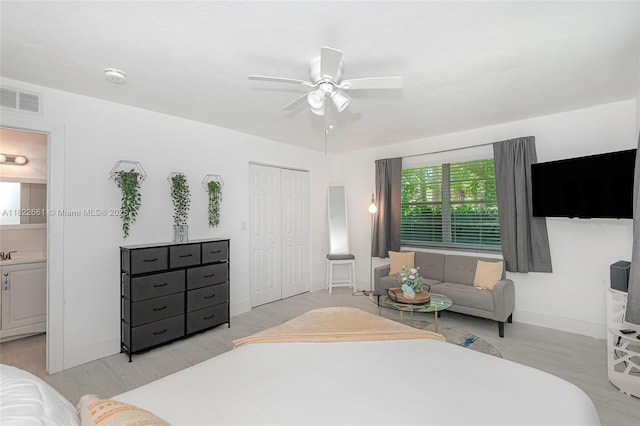 201 Columbus Pkwy, Hollywood, FL 33021 - bedroom featuring wood finished floors, a closet, a ceiling fan, and ensuite bath