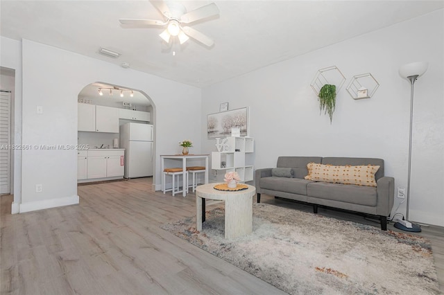 201 Columbus Pkwy, Hollywood, FL 33021 - living area with ceiling fan, light wood-style flooring, and arched walkways
