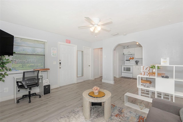 201 Columbus Pkwy, Hollywood, FL 33021 - living room with arched walkways, ceiling fan, an office area, and light wood-style flooring