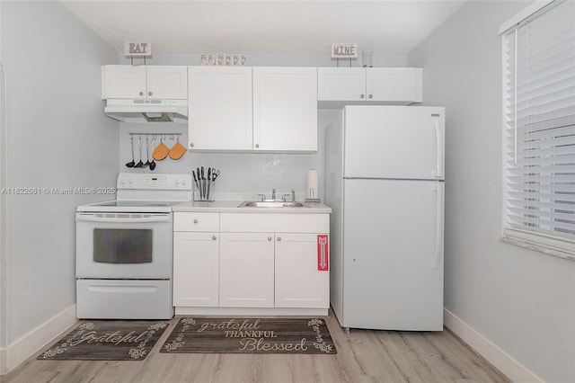 201 Columbus Pkwy, Hollywood, FL 33021 - kitchen featuring white appliances, under cabinet range hood, light wood finished floors, and white cabinets