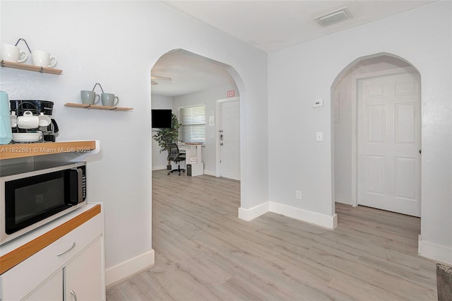 201 Columbus Pkwy, Hollywood, FL 33021 - corridor with light wood finished floors and arched walkways