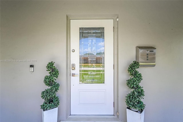 entrance to property with stucco siding