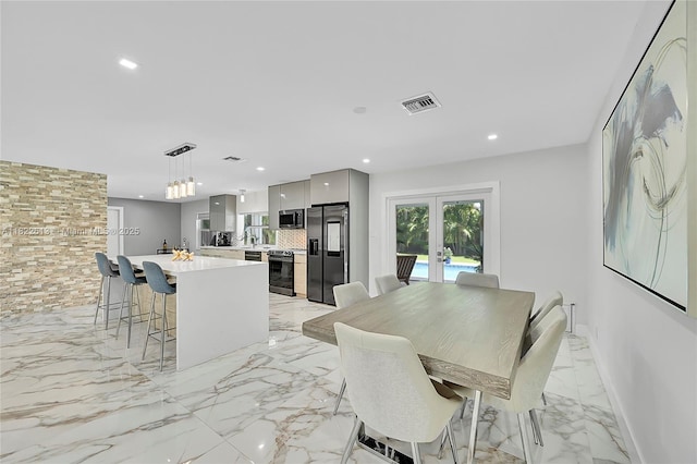 7481 NW 14th St, Plantation, FL 33313 - dining area featuring french doors, light marble finish floors, and recessed lighting