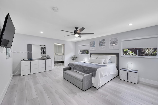 bedroom with light wood-style flooring, recessed lighting, ceiling fan, and connected bathroom