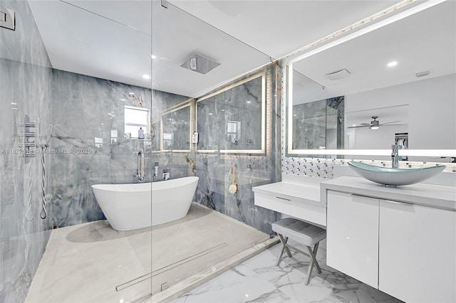 7481 NW 14th St, Plantation, FL 33313 - bathroom featuring marble tiled floors, a marble finish shower, a soaking tub, vanity, and tile walls