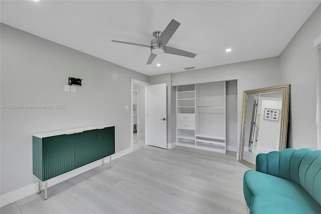 living area with ceiling fan, recessed lighting, and light wood finished floors