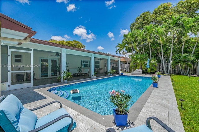 view of pool featuring a ceiling fan, a patio area, a fenced backyard, and french doors