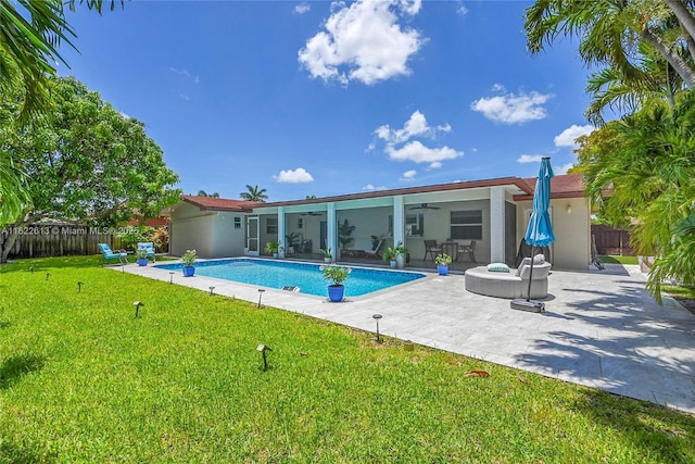 view of swimming pool featuring a ceiling fan and a patio area