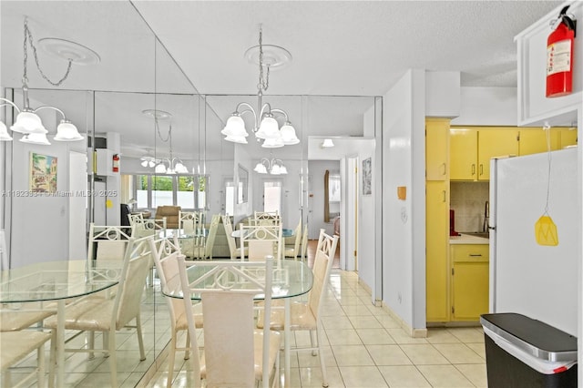 1030 SW 11th St Unit 8M, Hallandale Beach, FL 33009 - dining space with a chandelier and light tile patterned floors