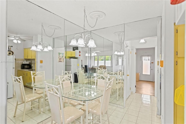 1030 SW 11th St Unit 8M, Hallandale Beach, FL 33009 - dining area with light tile patterned floors, a chandelier, and ceiling fan