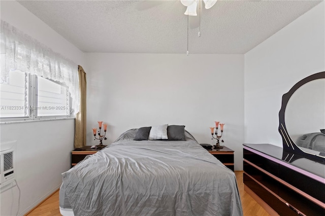 1030 SW 11th St Unit 8M, Hallandale Beach, FL 33009 - bedroom featuring light wood-style floors, a textured ceiling, and a ceiling fan