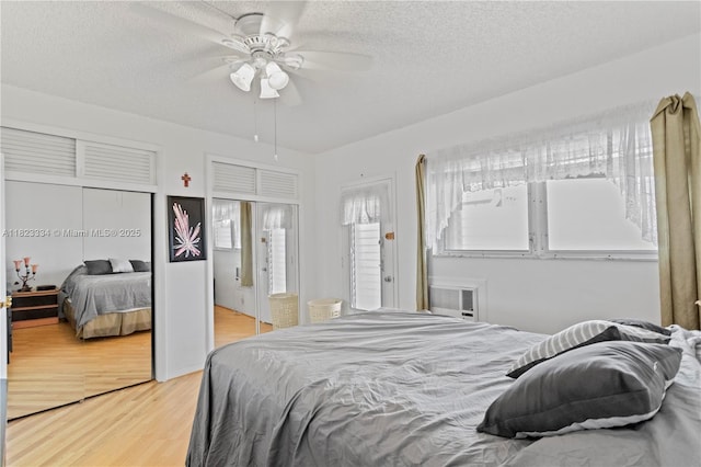 1030 SW 11th St Unit 8M, Hallandale Beach, FL 33009 - bedroom with light wood-style flooring, multiple closets, a textured ceiling, and ceiling fan