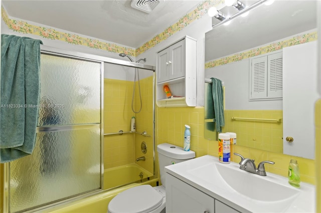 1030 SW 11th St Unit 8M, Hallandale Beach, FL 33009 - bathroom featuring vanity, enclosed tub / shower combo, tile walls, and wainscoting