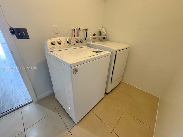 8135 Southgate Blvd, North Lauderdale, FL 33068 - laundry room featuring separate washer and dryer, light tile patterned floors, and healthy amount of natural light