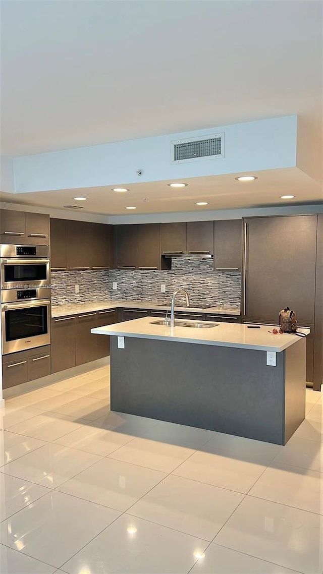 7661 NW 107th Ave Unit 207, Doral, FL 33178 - kitchen featuring modern cabinets, double oven, light countertops, tasteful backsplash, and recessed lighting