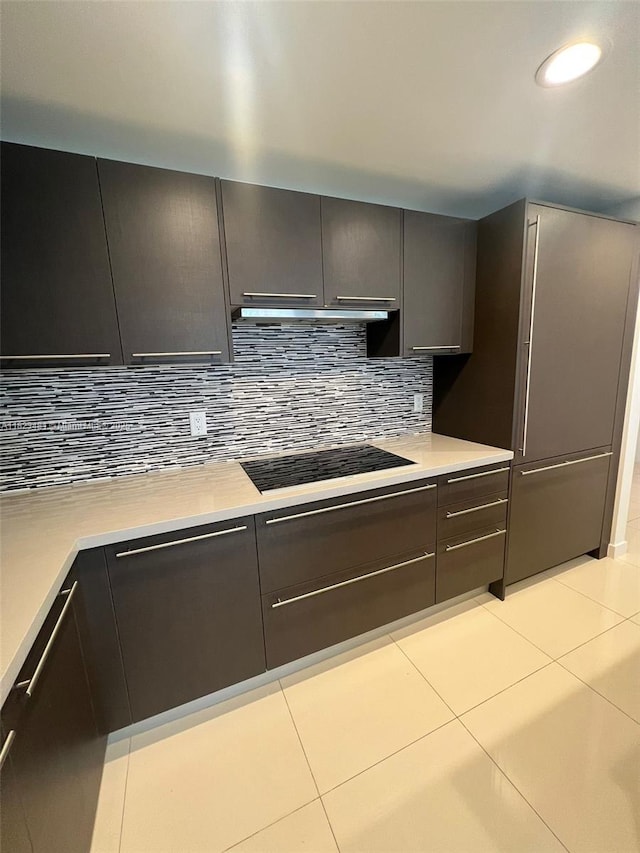 7661 NW 107th Ave Unit 207, Doral, FL 33178 - kitchen featuring black stovetop, light tile patterned floors, light countertops, tasteful backsplash, and recessed lighting