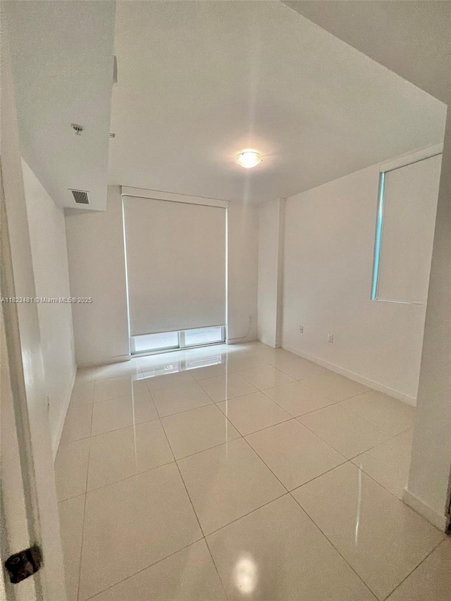 7661 NW 107th Ave Unit 207, Doral, FL 33178 - spare room with tile patterned flooring