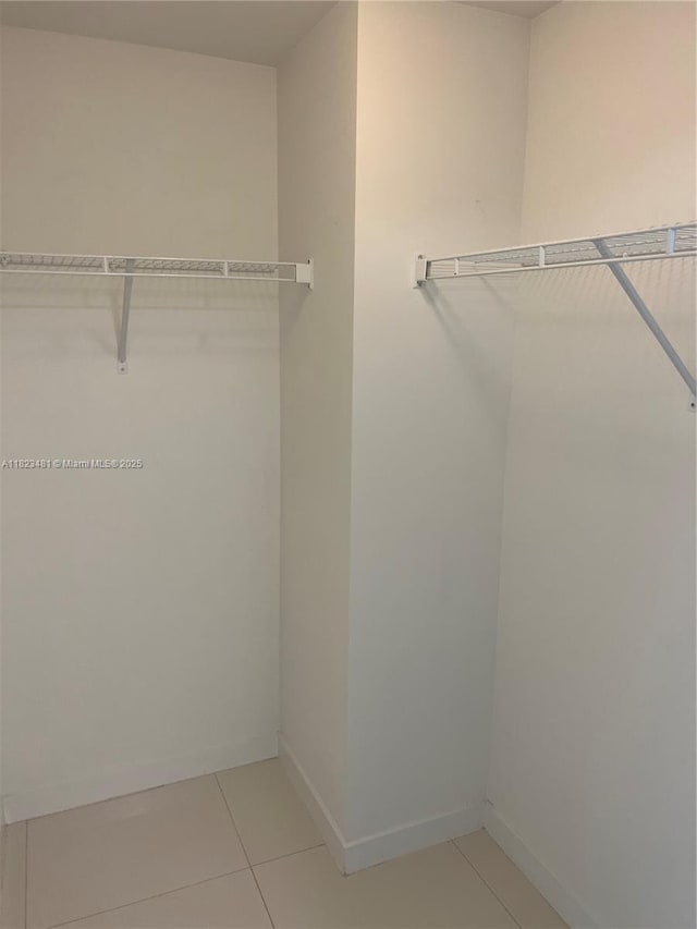 7661 NW 107th Ave Unit 207, Doral, FL 33178 - walk in closet featuring light tile patterned floors