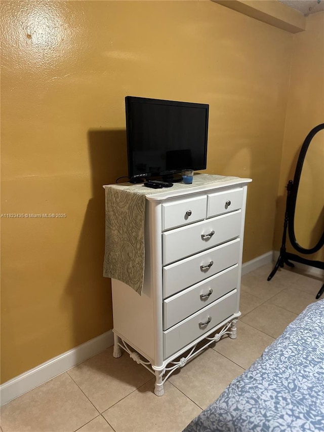 4050 NW 135th St Unit 8-9, Opa-Locka, FL 33054 - bedroom featuring baseboards and light tile patterned floors