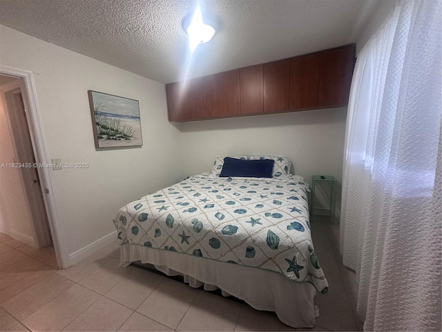 4050 NW 135th St Unit 8-9, Opa-Locka, FL 33054 - bedroom featuring light tile patterned flooring and a textured ceiling