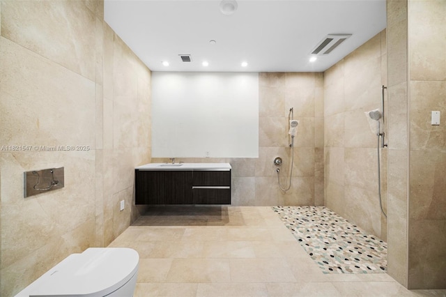 275 Giralda Ave Unit 6A-B, Coral Gables, FL 33134 - bathroom featuring a walk in shower, tile walls, recessed lighting, vanity, and tile patterned floors