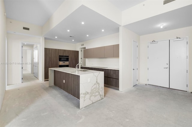 275 Giralda Ave Unit 6A-B, Coral Gables, FL 33134 - kitchen featuring modern cabinets, concrete flooring, recessed lighting, a kitchen island with sink, and black electric cooktop