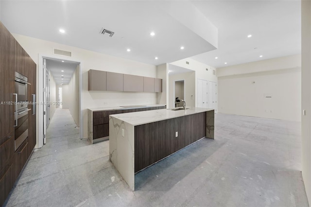 275 Giralda Ave Unit 6A-B, Coral Gables, FL 33134 - kitchen with modern cabinets, a large island, concrete floors, black electric stovetop, and light stone counters