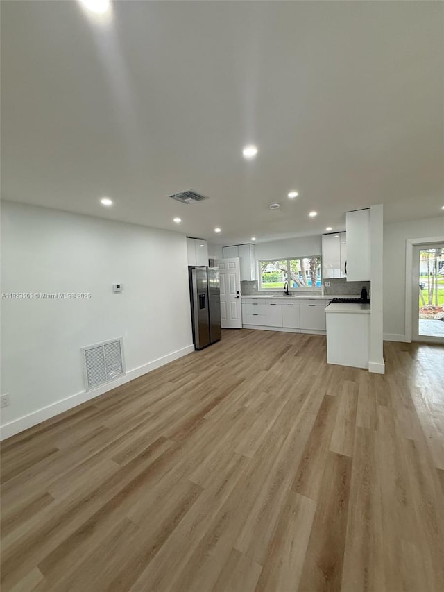 9934 SW 195th St, Cutler Bay, FL 33157 - unfurnished living room with recessed lighting, plenty of natural light, and light wood-style flooring